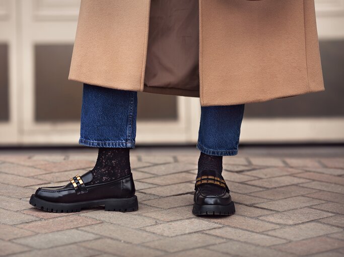 weibliche Beine in Jeans, schwarze Loafer | © GettyImages/AnnaZhuk